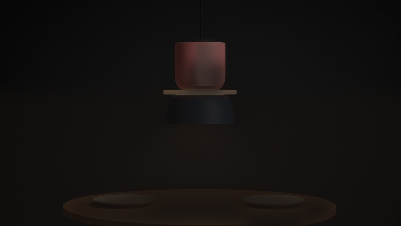 Luminária pendente Macaron rosa e azul-marinho desligada sobre uma mesa de jantar.