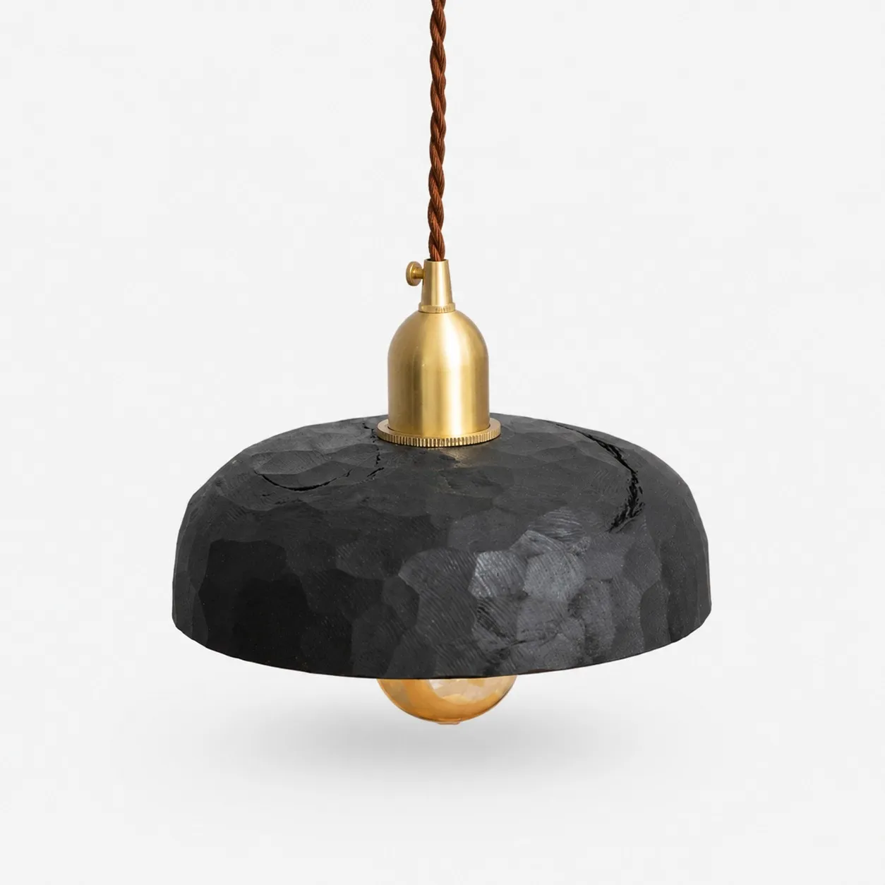 Black carved wood pendant lamp on a clean background